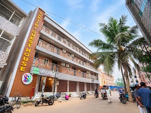 A multi-story building with a sign for 'Shree Marq' and a visible entrance.