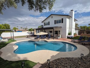 A residential property with a swimming pool, outdoor seating, and a covered patio area. - Pool, Spa, & Games - Luxury Scottsdale Retreat Near Kierland (Scottsdale)
