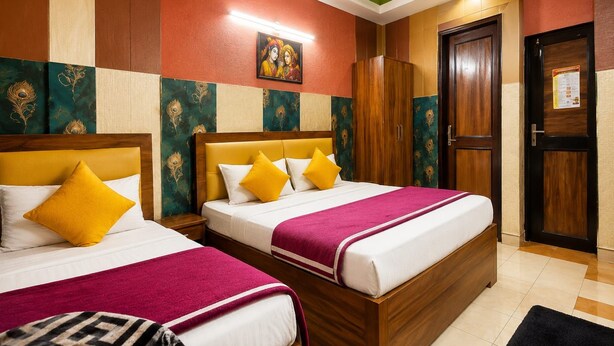 A hotel room with two beds, a wooden wardrobe, a door, and a green ceiling. - The Viyan Vrindavan (Dhorera Khadar)