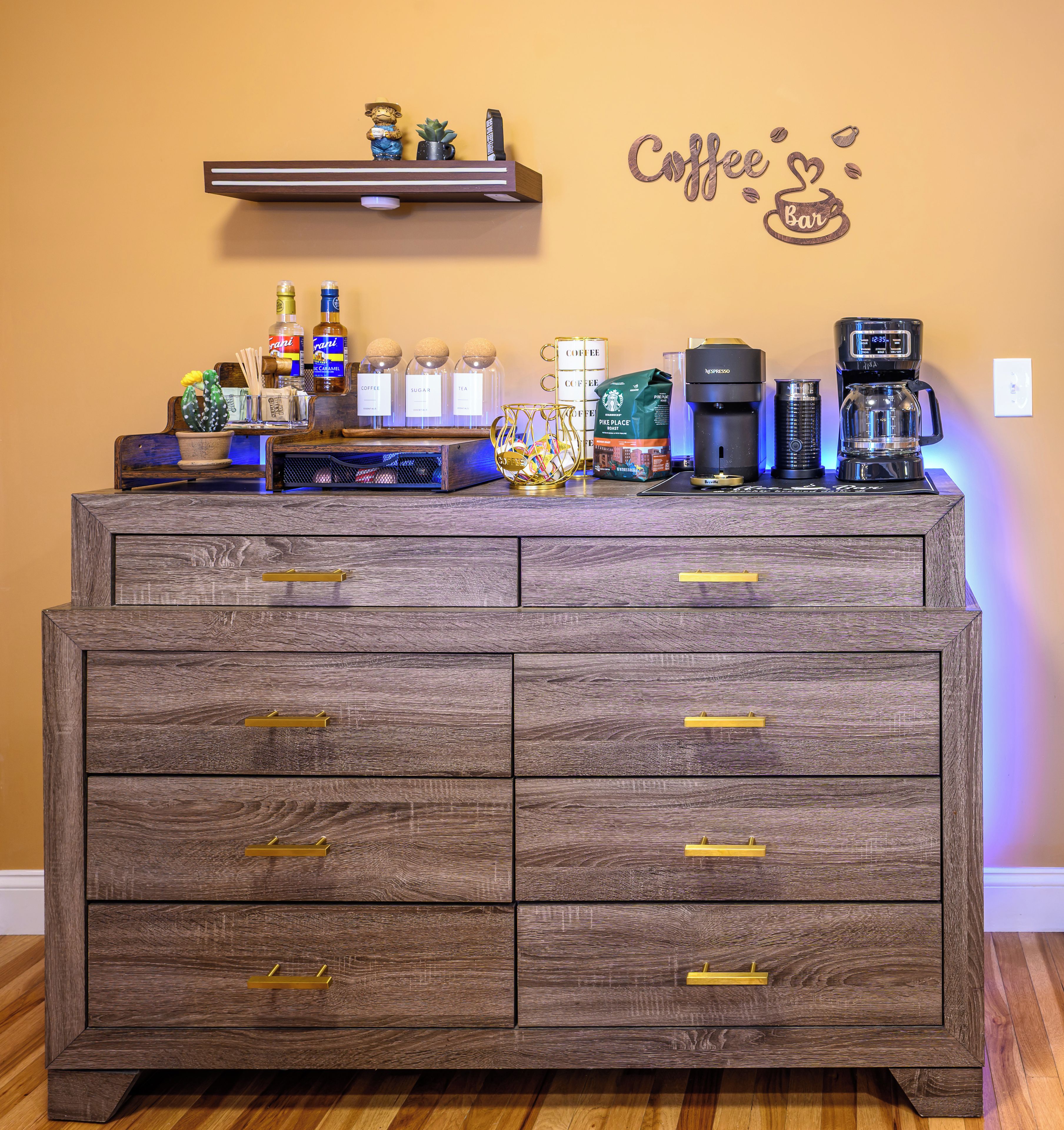 A wooden dresser with drawers and a shelf above it.