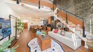 A spacious living area with a staircase, a dining area, and a kitchen. - Tonight Homestay West Nanjing Road SH (SHANGHAI)