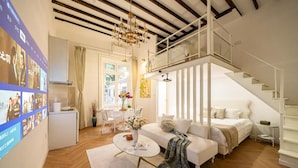 A modern living room with a sofa, coffee table, and a staircase. - Tonight Homestay West Nanjing Road SH (SHANGHAI)