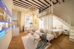 Een moderne woonkamer met een bank, salontafel en een trap.