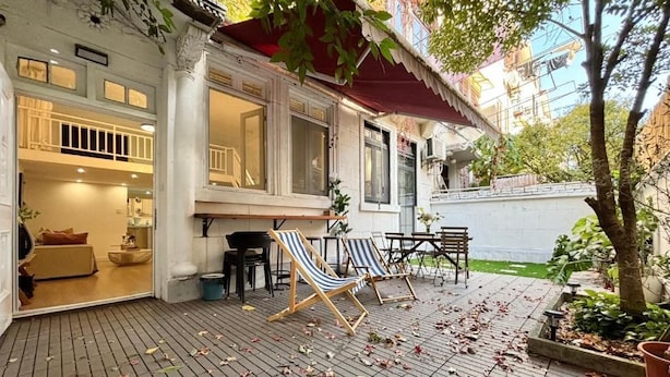 A covered patio with a brick floor, outdoor seating, and a view of the interior. - Tonight Homestay West Nanjing Road SH (SHANGHAI)