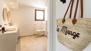 A bathroom with a white sink, a toilet, and a window. - Domaine Du Mirage (Bormes-Les-Mimosas)
