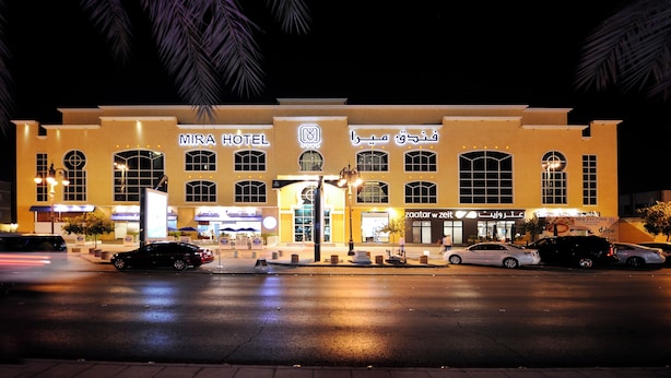 A hotel with a prominent sign, multiple windows, and a well-lit entrance. - Mira Hotel (Riyadh)