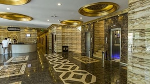 A hotel lobby with marble flooring, a reception desk, and elevators. - Sarot Termal Park Resort & Spa (Mudurnu)