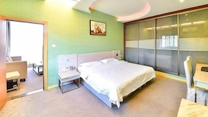 A modern hotel room with a large bed, a desk, and a sliding glass door to the outside. - Super 8 Quanzhou Anxi Longhu (Quanzhou)