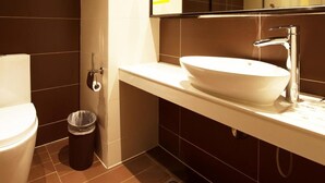 A modern bathroom with a white sink, chrome faucet, and a mirror above it. - IU Hotel (Luoyang)