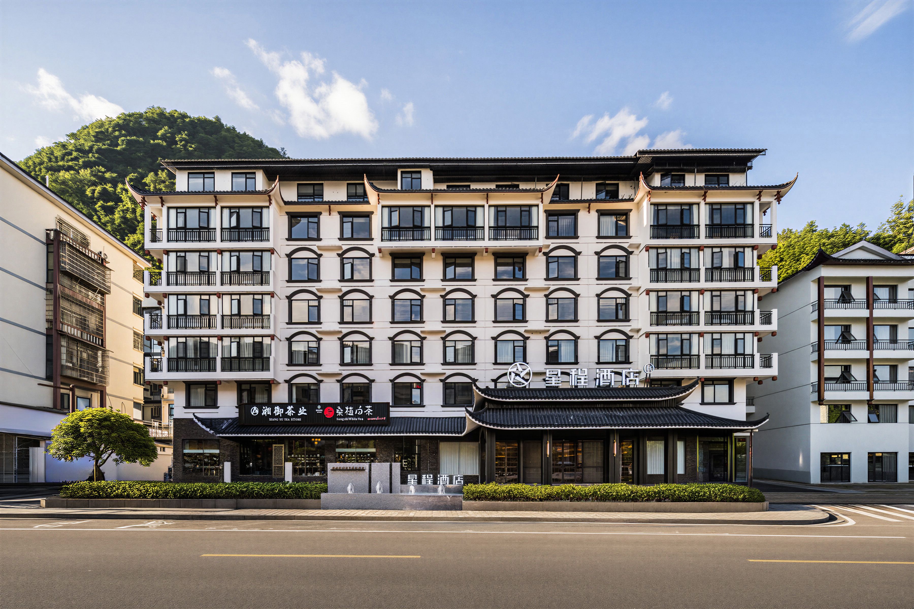 A multi-story building with a traditional architectural style, featuring a row of windows and balconies on each floor.