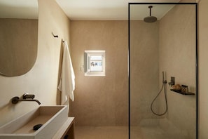 A bathroom with a shower, a sink, and a mirror. - Parocks Luxury Hotel and Spa (Paros)