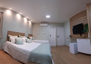 A bedroom with two beds, a TV, a small fridge, and an air conditioning unit. - Pureza Hotel (Timon)