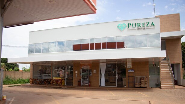 A hotel named PUREZA HOTEL with a modern facade, large windows, and a visible entrance. - Pureza Hotel (Timon)