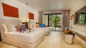A hotel room with a large bed, a desk, and a view of palm trees through the window. - Family Selection At Grand Palladium Kantenah Resort & Spa (Kantenah)
