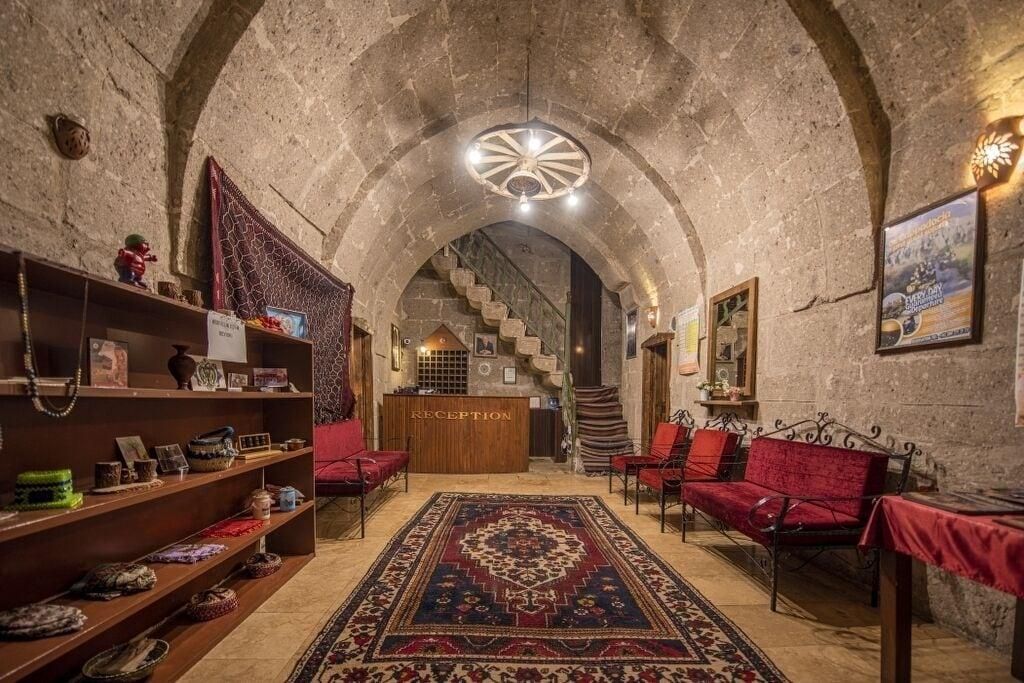 A reception area with a reception desk, red seating, and a patterned carpet.