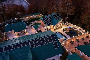 A resort with multiple buildings, solar panels on roofs, outdoor seating, and a swimming pool. - Garni Eco Hotel Elite Kolasin (Kolašin)