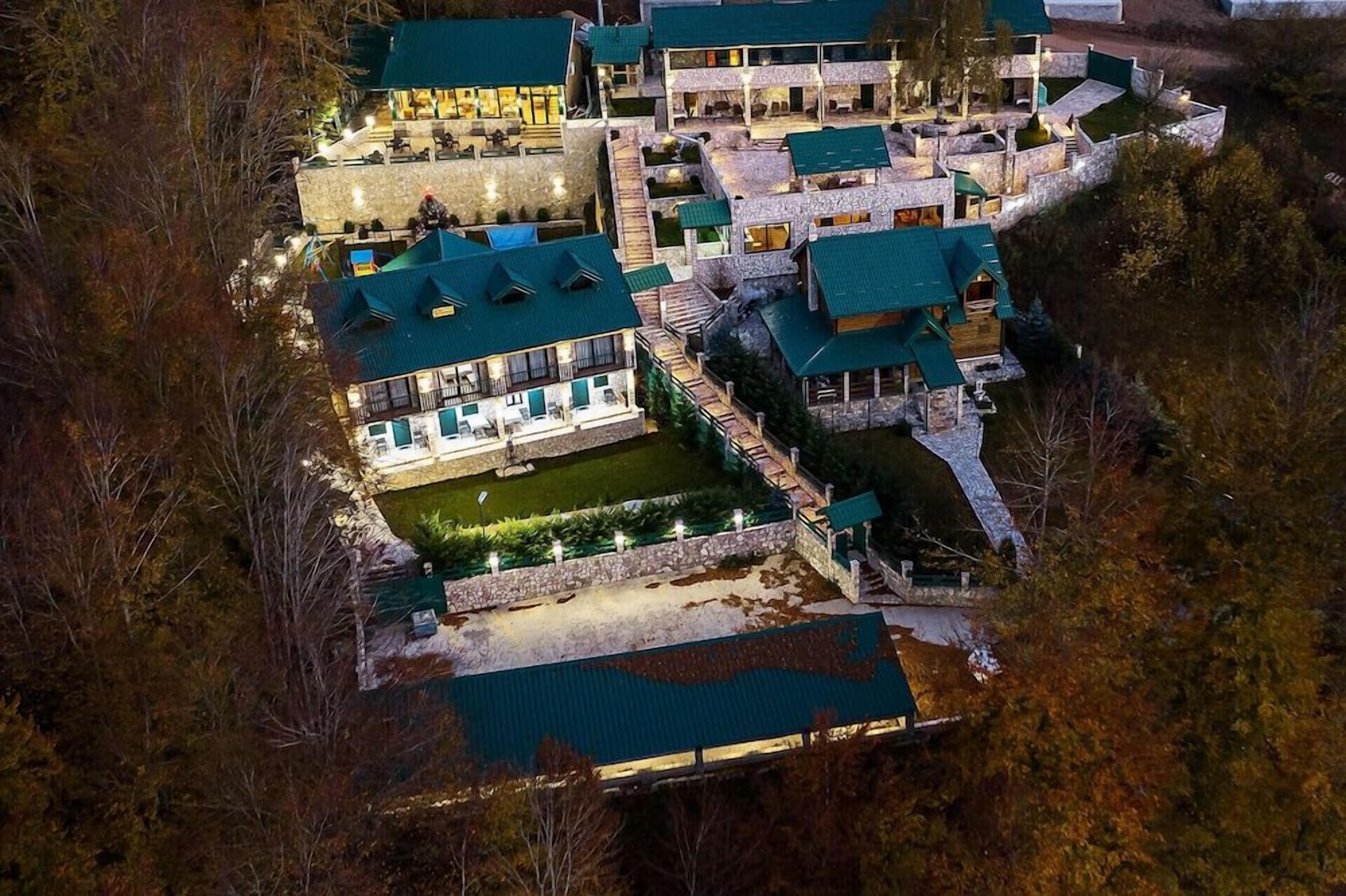 A multi-story hotel with a stone facade, multiple balconies, and a courtyard.