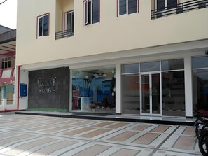 A hotel with a modern facade, large glass windows, and a visible entrance.