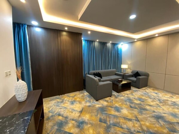 Una sala de estar moderna con un conjunto de sofá, una mesa de centro y una lámpara.