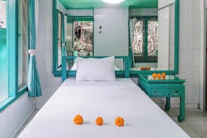 A room with a bed, a window with curtains, a small table with flowers, and a mirror. - Belvilla Padma Legian Resort Near Monkey Forestnearubud Palace (Ubud)
