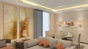 A modern living room with a sofa, a coffee table, and a dining area with chairs and a table. There are abstract paintings on the walls and a window with curtains.