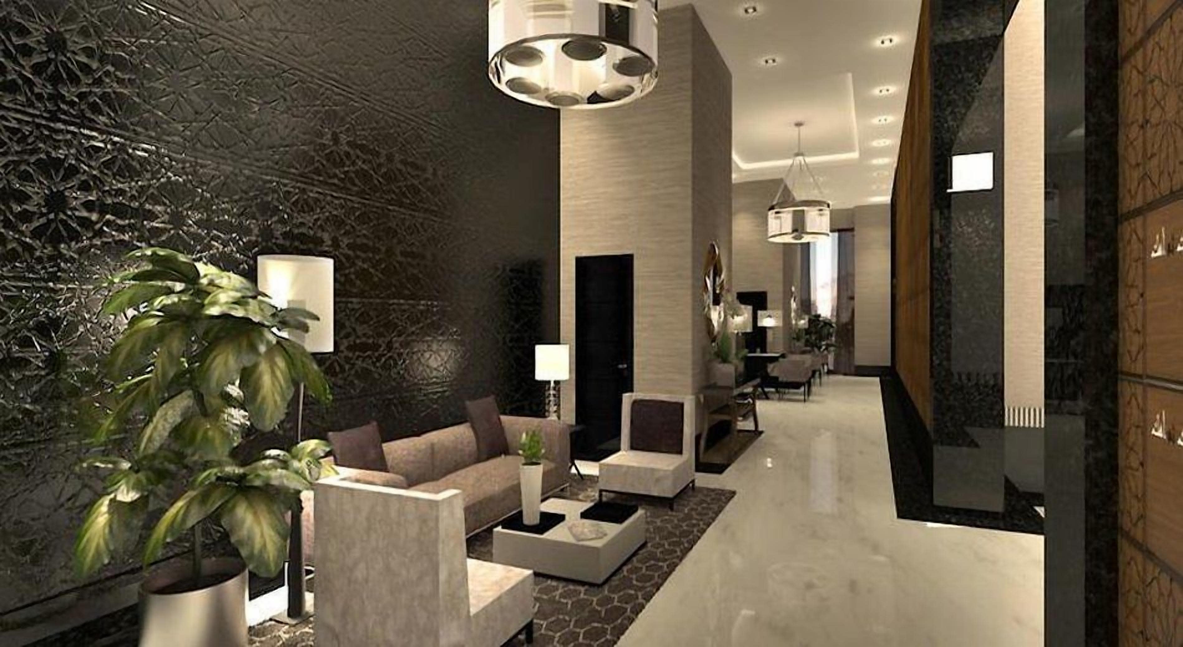 A modern interior with a reception area, seating, and a plant.