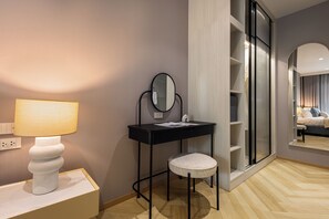 A modern bathroom with a vanity, mirror, and a stool. - Bang Tao - Spacious Private Balcony (Tambon Choeng Thale)