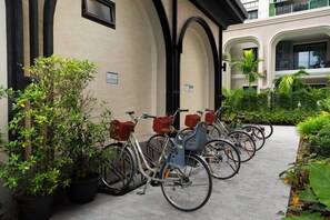 A row of bicycles parked outside a building with a sign indicating bicycle parking. - Bang Tao - Spacious Private Balcony (Tambon Choeng Thale)