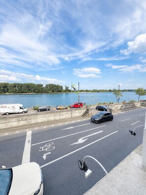 A parking area with a view of a lake and trees.