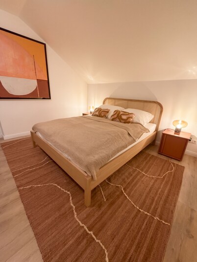 Designer attic apartment with a kitchen and a smart TV