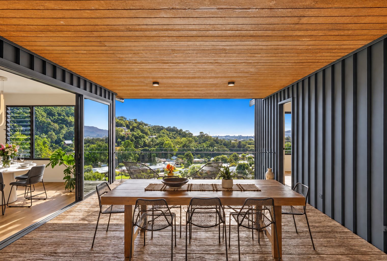 Covered alfresco dining with sweeping hillside views and modern design