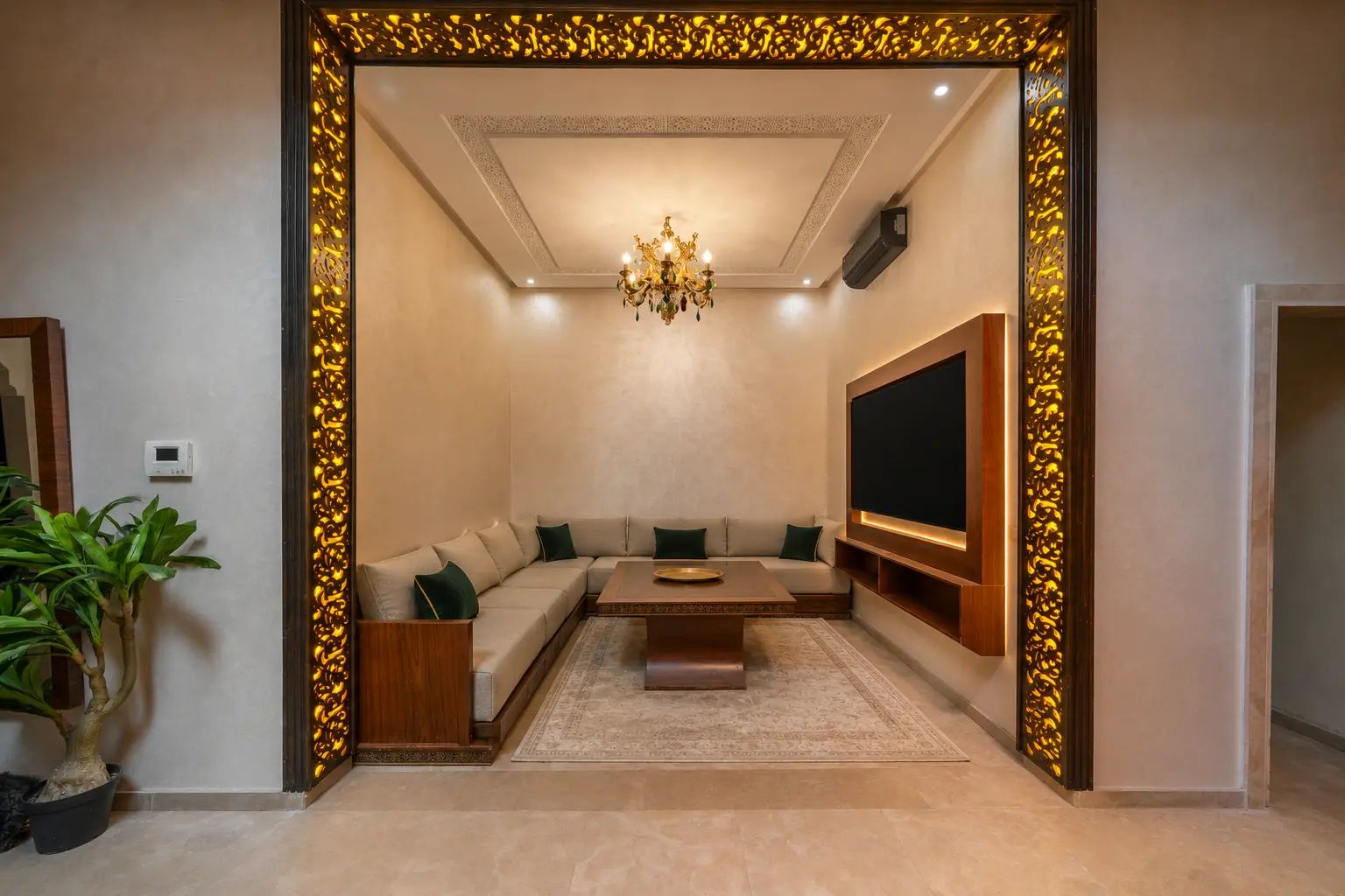 A modern living room with a sectional sofa, a coffee table, a flat-screen TV, and a decorative wall panel.