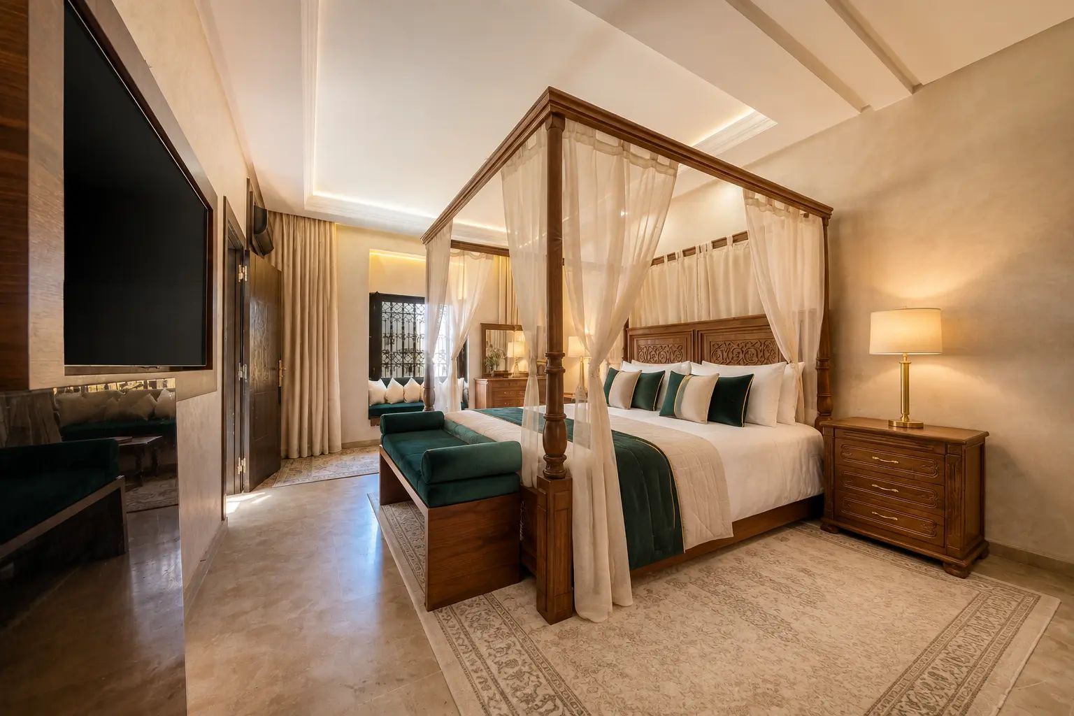 A four-poster bed with a canopy, a television mounted on the wall, and a wooden nightstand with a lamp.
