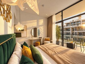A modern hotel room with a large bed, a round mirror, a desk, and a balcony with a view of the city. - Pool Days. City Nights. Your Private VILLA Escape (دبي)
