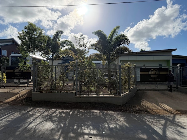 A gated residential area with a sign for 'Roslyn Suite 1 & 2' and 'Olivia Suite 1'.