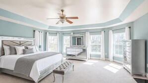 A bedroom with a bed, a vanity, a ceiling fan, and a window. - Private 5BR Estate with Hot Tub, Pool & Movie Room (Hughesville)