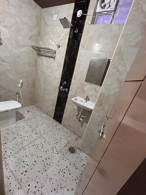 A bathroom with a shower, sink, and toilet. - Dumzy Living (Hyderabad)