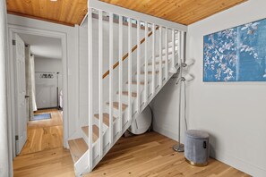 A staircase with white railings and wooden steps leading to an upper floor.