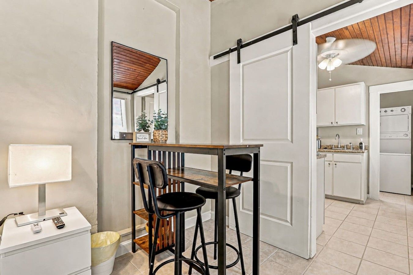 A kitchen with white cabinets, a countertop with a sink, and a stove.