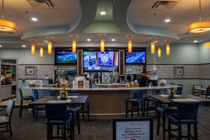 A bar area with multiple screens displaying sports content, bar counters, and seating arrangements. - Low-Tox Theme Park Retreat • 2 Private Theaters (Four Corners)