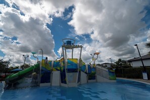 A water park with a central water feature and slides. - Low-Tox Theme Park Retreat • 2 Private Theaters (Four Corners)