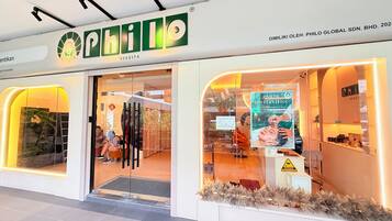 A spa with a glass entrance, a sign for 'PHILO HEAD SPA', and a 'Buy 1 Get 1 Free' offer.