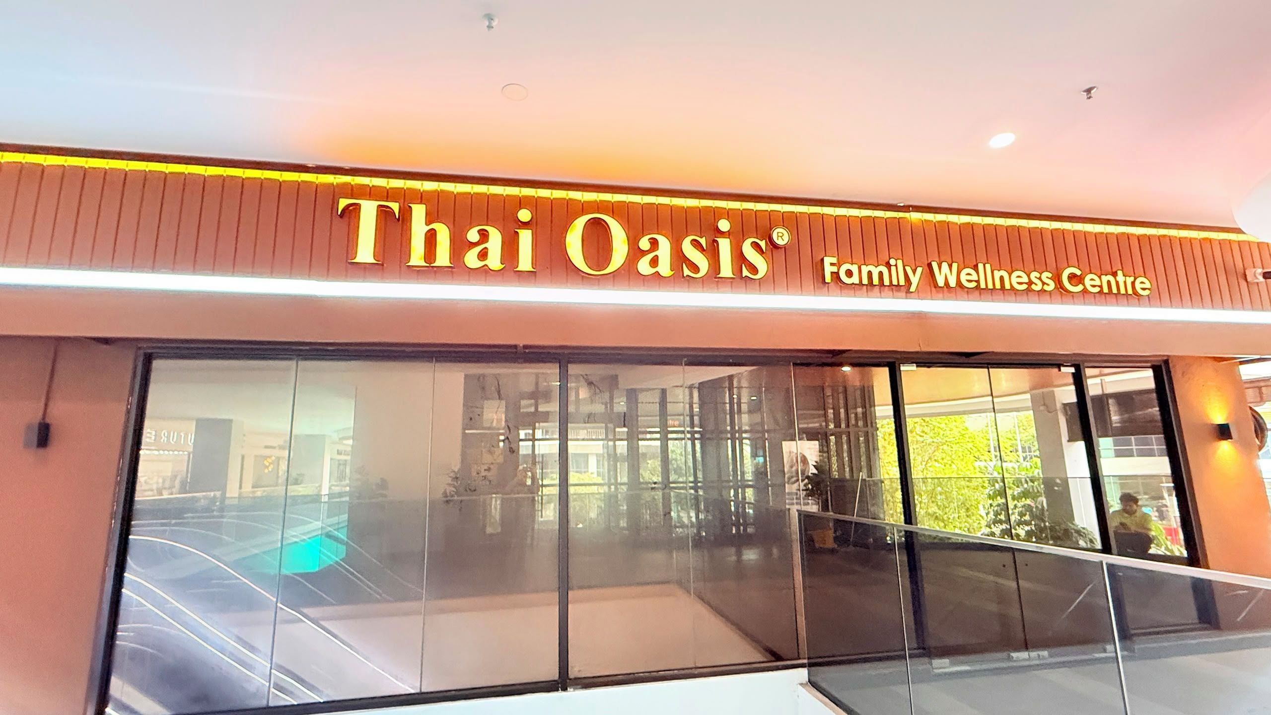 A Thai Oasis Family Wellness Centre with a large glass facade.