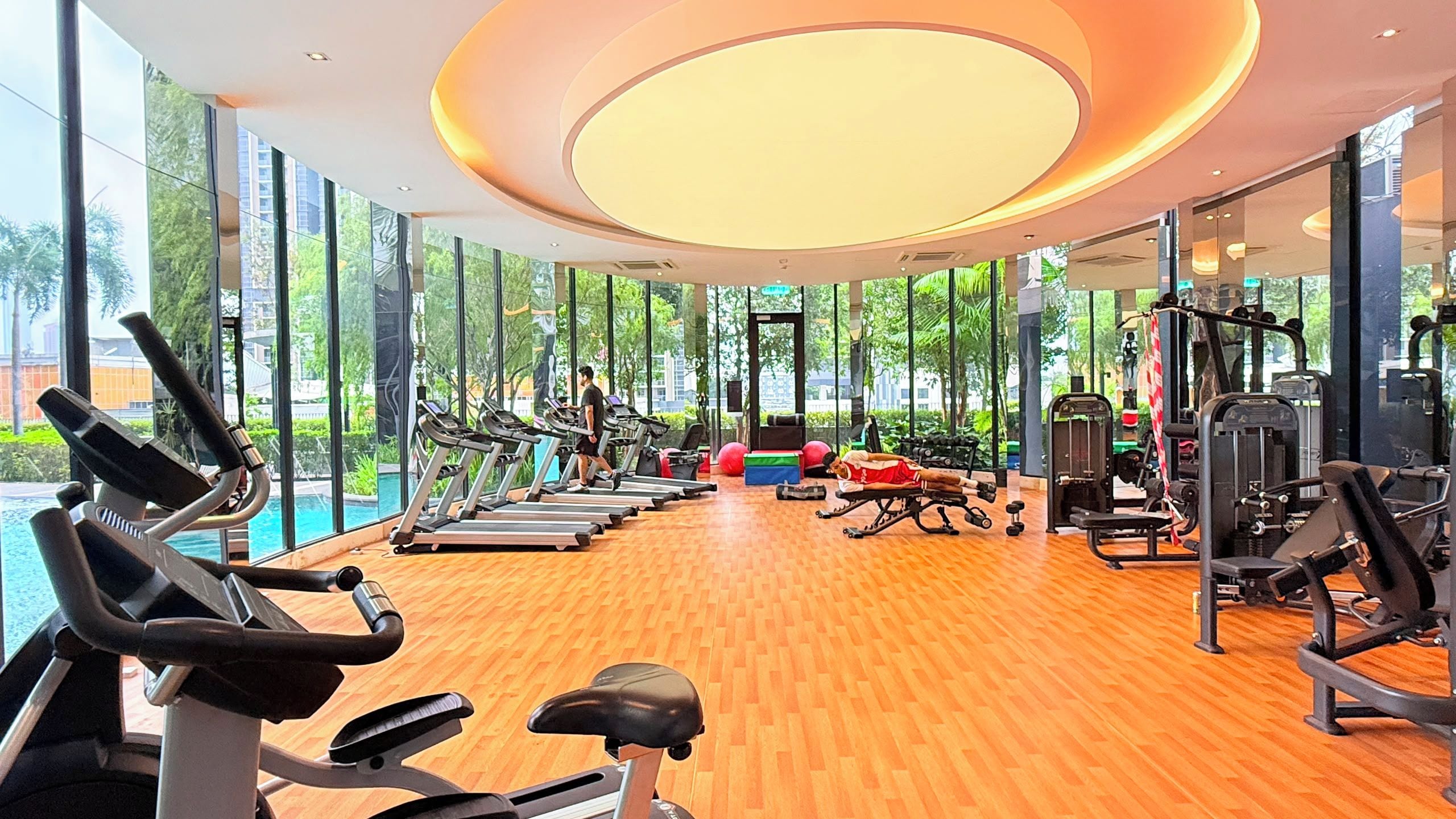 A gym with treadmills, weight machines, and exercise balls.