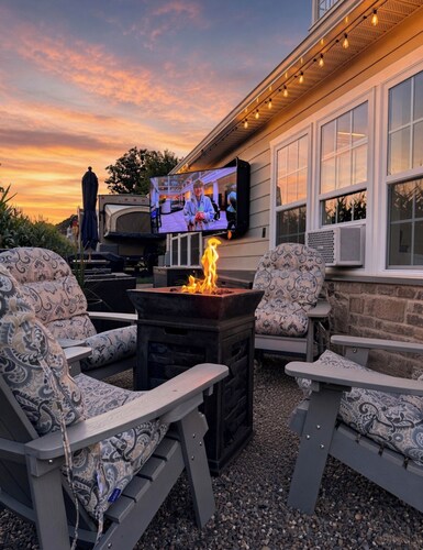 Charming recreational vehicle with a cozy sitting area, fire pit and a 65” tv.