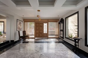 A spacious lobby with a marble floor, wooden doors, and a traditional chandelier. - Realx at Bait Assel by Spacey #85 (cairo)