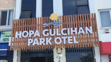 A hotel entrance with a sign reading 'HOPA GULCHIAN PARK HOTEL'.