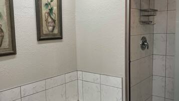 A bathroom with a bathtub, a shower, and a toilet.