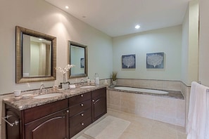 A modern bathroom with a double sink vanity, large mirrors, and two wall-mounted artwork pieces. - LUXURY WATERFRONT PENTHOUSE PRIVATE POOL 3 BEDROOM 3 BATHROOM (Lowlands)