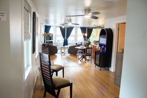 A hotel room with a dining area, a TV, and a minibar.